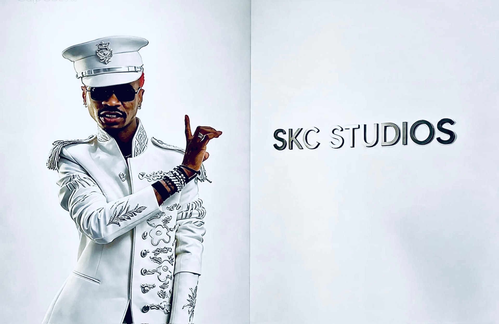 Seal Kamson at the SKC Studios signage wall